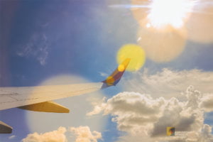 Welcome to Reinventing Moments 5 Clouds, sky, and sun rays seen through a Southwest Airlines window en route to Orlando, Florida