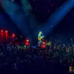 Eric Church performing live at Crypto.com Arena, May 2022. He's playing guitar and singing, illuminated by spotlights.