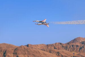Vegas Jets and River Runs 8 Two US Air Force Thunderbirds F-16s in solo flight; #5 is upside down with "5" printed inversely; #6 is flying normally at Nellis AFB Airshow 2025.