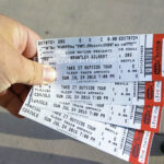 A hand holding four fanned-out Live Nation tickets for a Brantley Gilbert concert at the Sleep Train Amphitheatre on July 24, 2016.