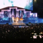 The band Lady A performing on a stylishly lit stage in front of a large crowd at an amphitheater during their "You Look Good World Tour."