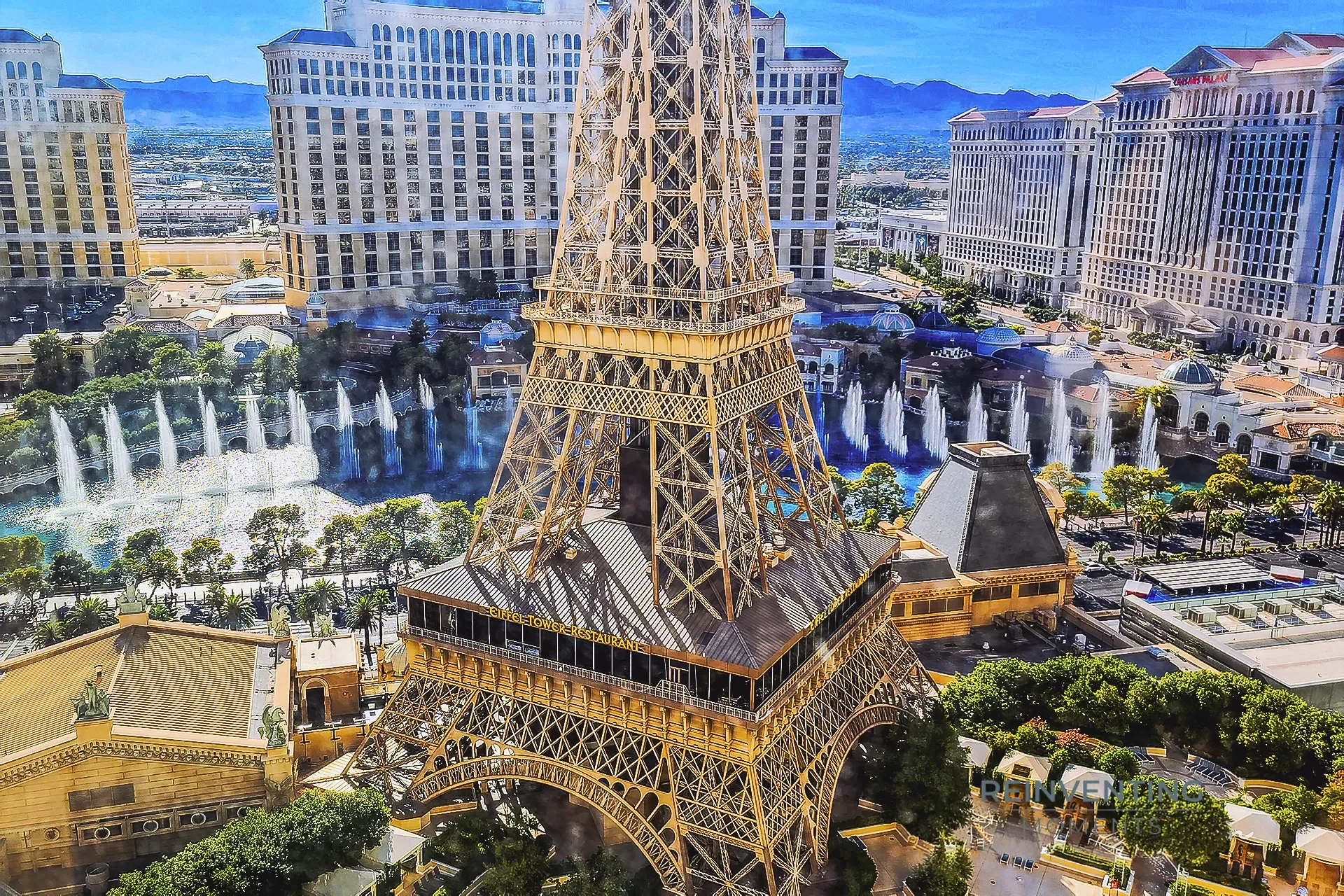 High-angle daytime view from a 28th-floor Paris Las Vegas room looking down at the Eiffel Tower, Bellagio Fountains, and Caesars Palace